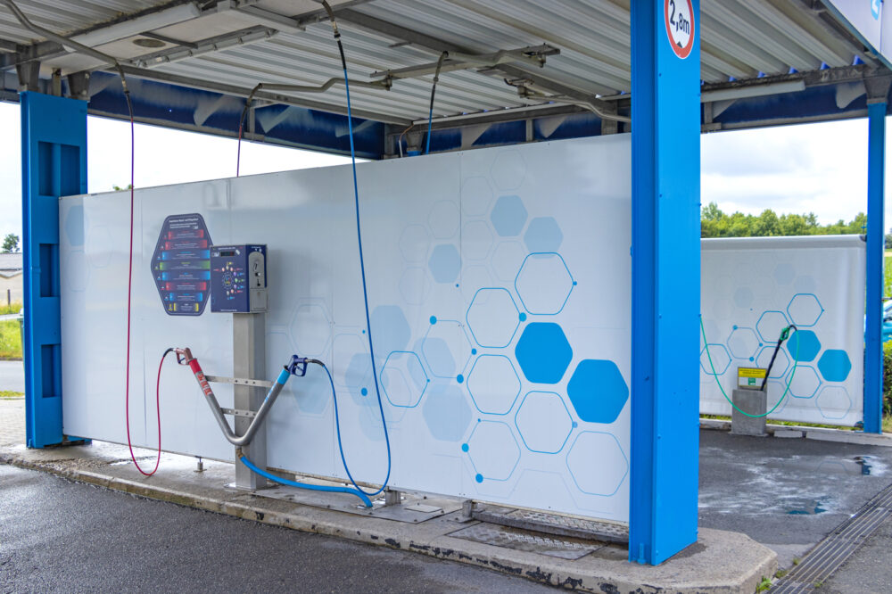 Waschbox der Clean Unit SB-Waschanlage in Neustadt an der Orla mit Hochdruckreiniger und Powerschaum für eine gründliche Fahrzeugreinigung.